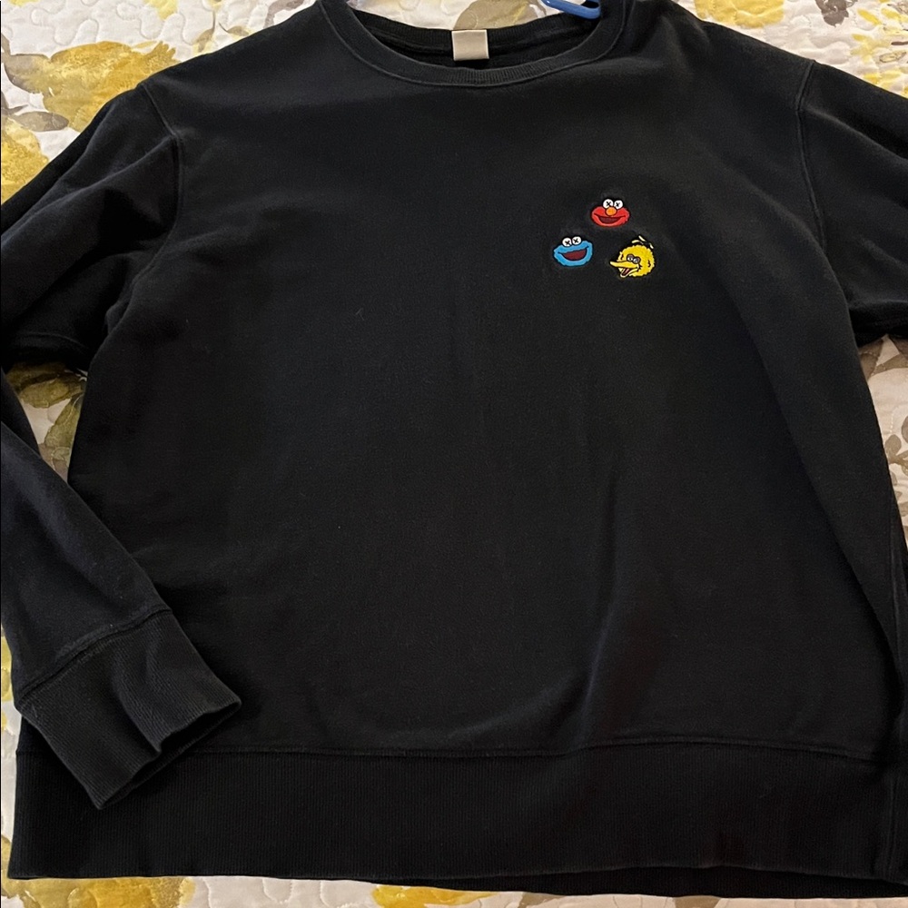 KAWS Black Crewneck with Red, Blue & Yellow Embroidered Faces Uniqlo